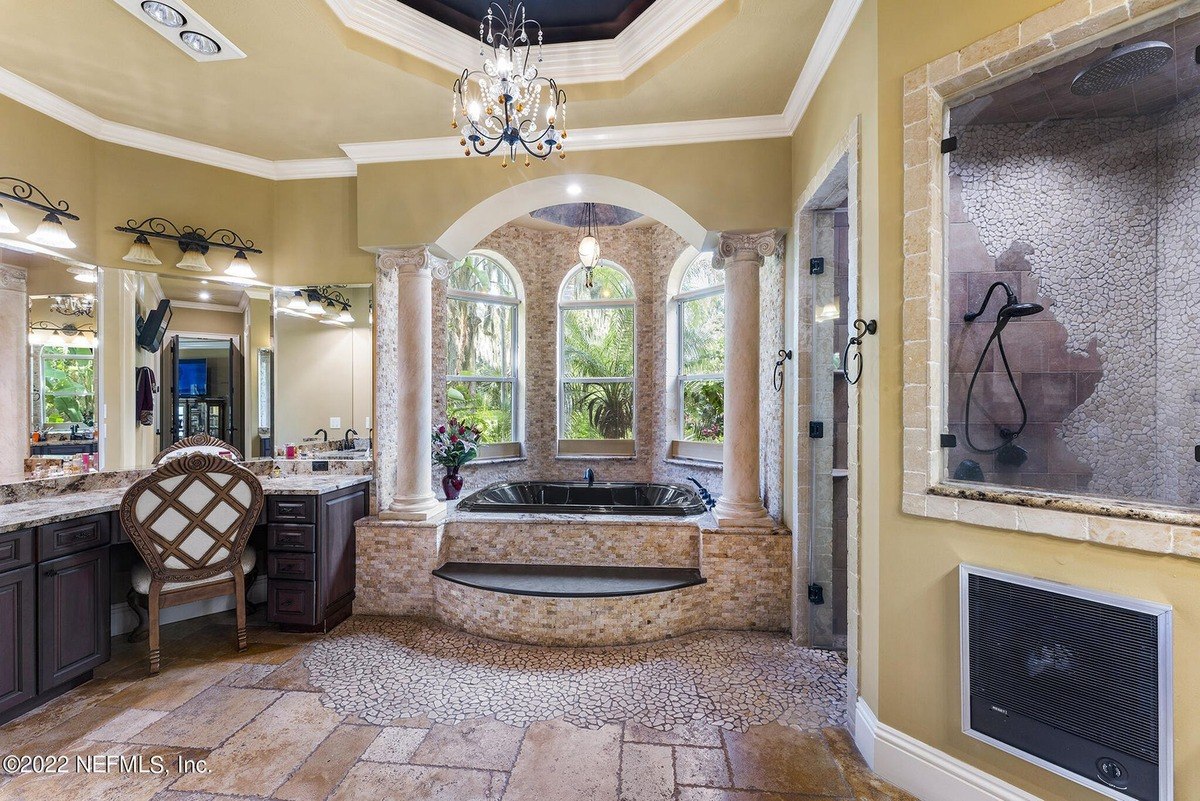 Bathroom features a large soaking tub, double vanities, and a walk-in shower.