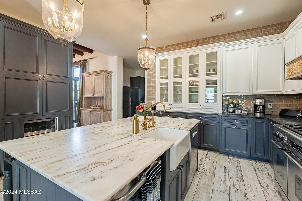 Modern kitchen layout with dual-tone cabinets and built-in appliances.