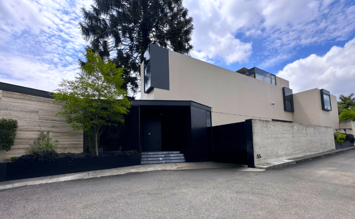 Modern facade featuring a geometric design with a combination of concrete and black accents.