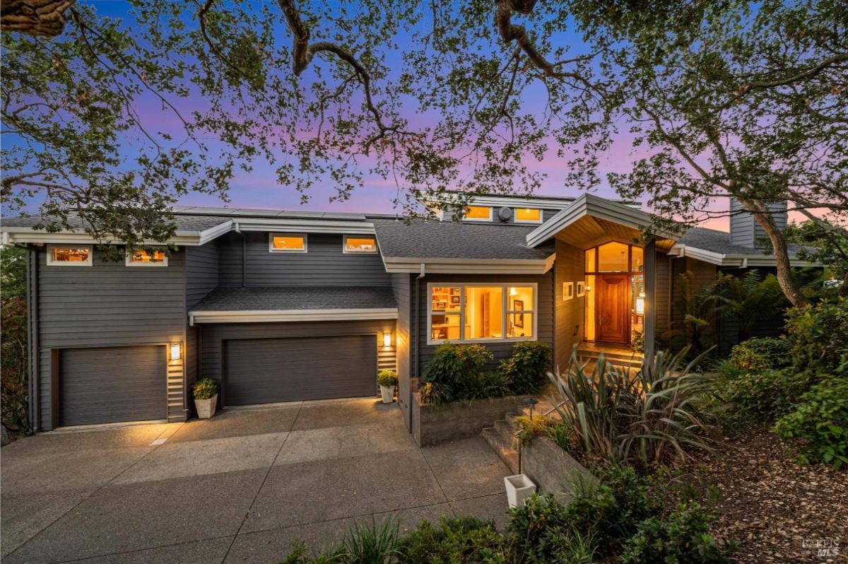 Two-story home with attached garage and landscaped yard.