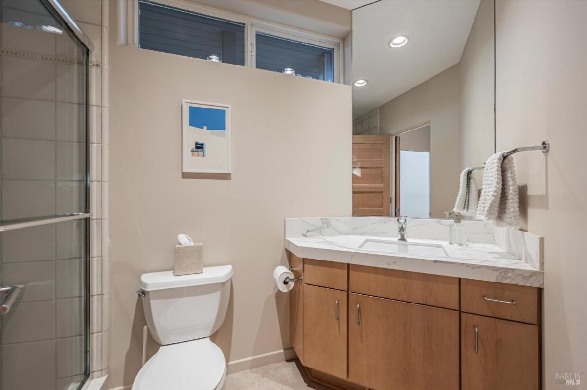 Ensuite bathroom with shower, sink, and toilet.