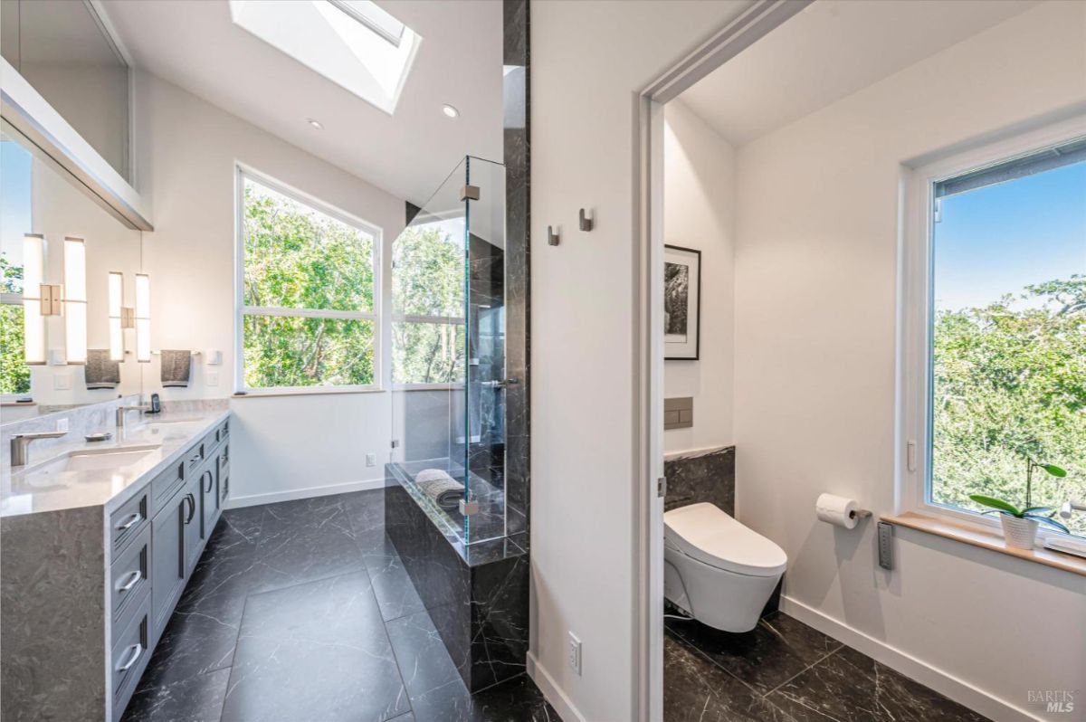 Ensuite bathroom with dual sinks, walk-in shower, and separate toilet.