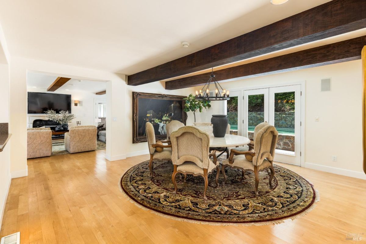 Dining room with access to a patio through double glass doors.