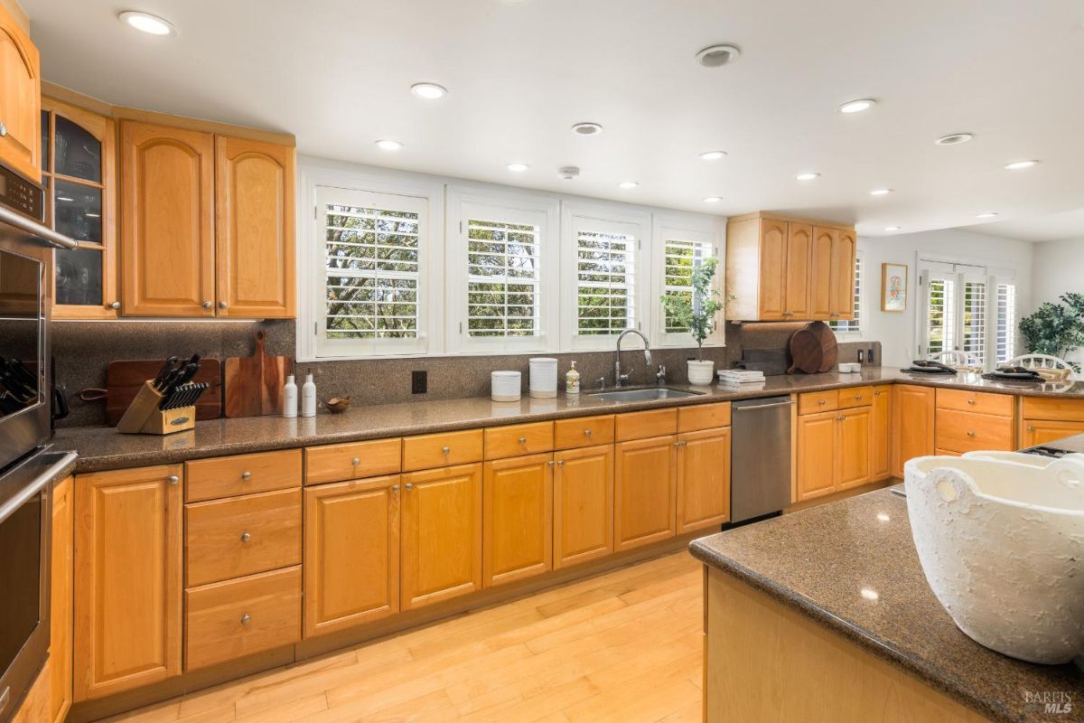 Kitchen with a long row of windows above the sink providing ample natural light.