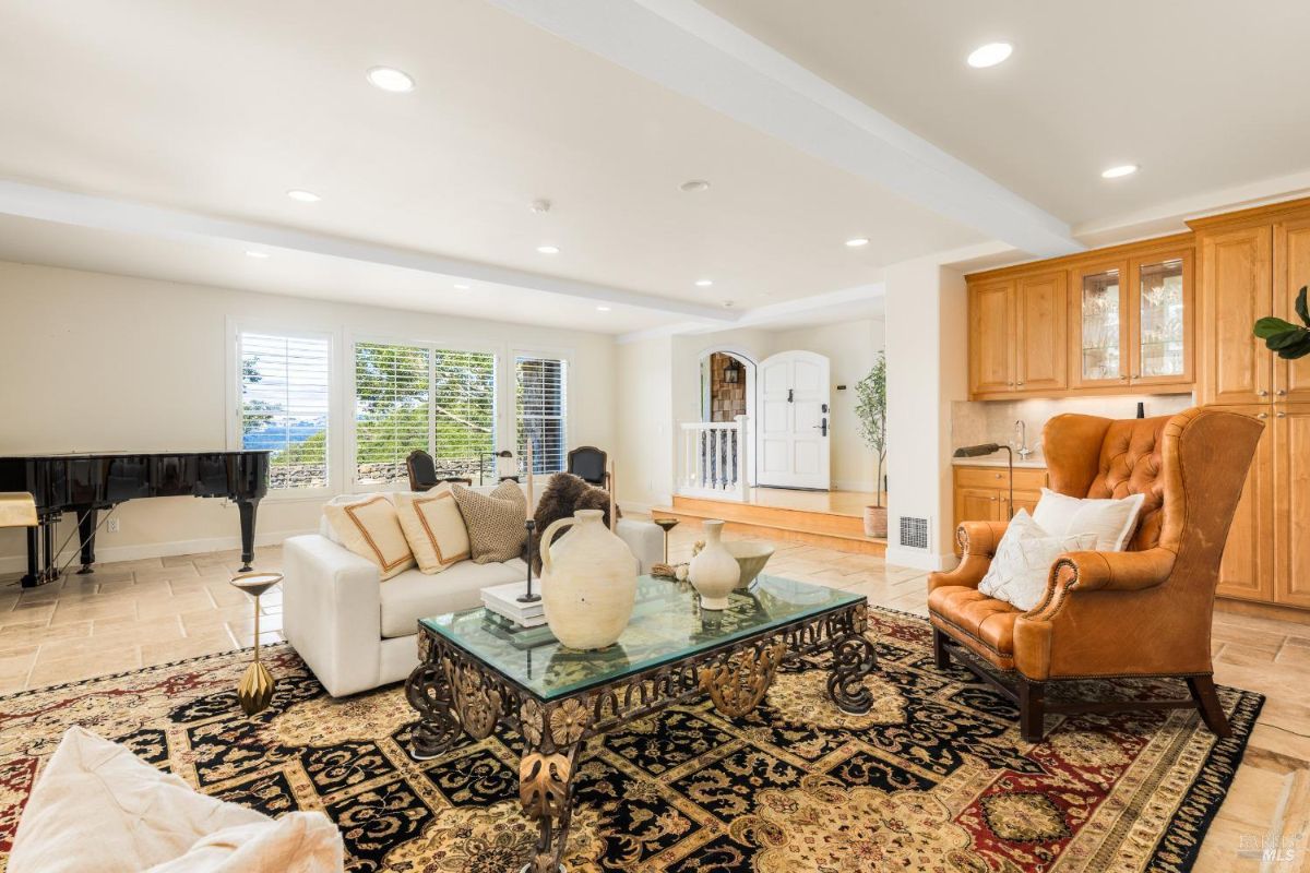 Living space with a piano, a glass coffee table, and a comfortable seating arrangement.