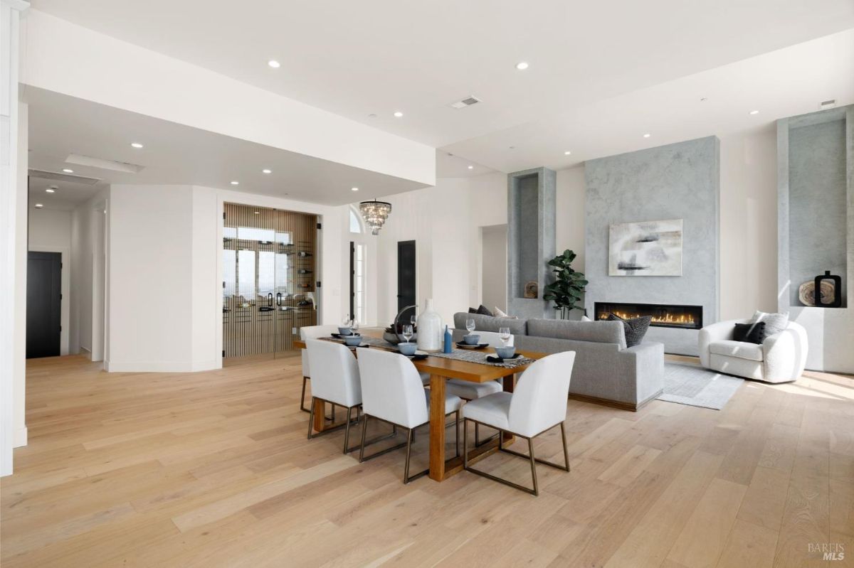 Open living and dining space featuring a fireplace and contemporary furniture.